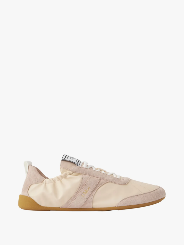 Beige suede and cream sneaker with white laces and tan gum sole, featuring a small gold 'Chloé' logo on the side.