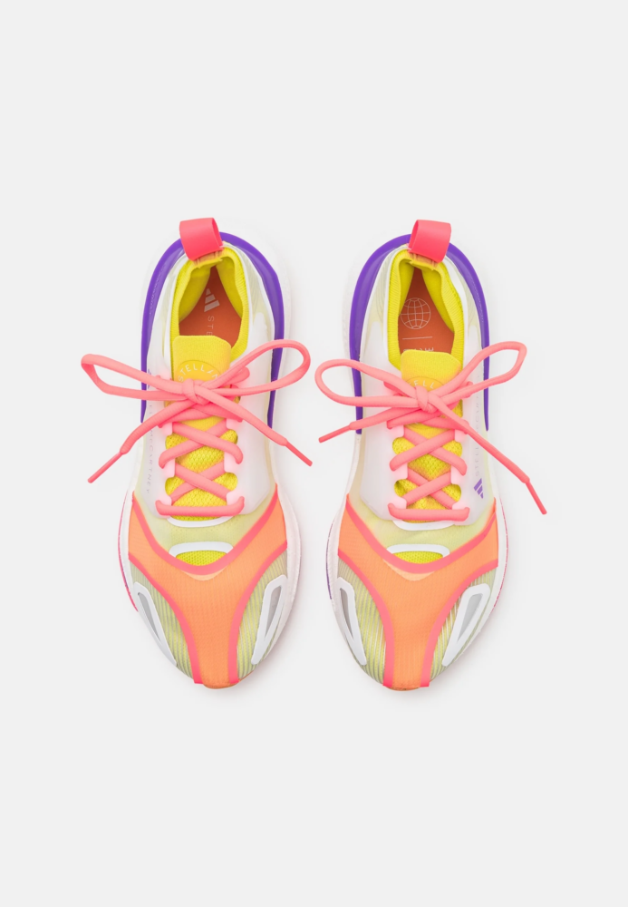 Bright multicolored sneakers viewed from above with pink laces and purple heel accents.