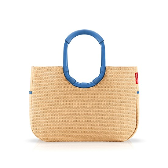 Beige woven straw tote bag with blue circular handles, standing upright against a white background.