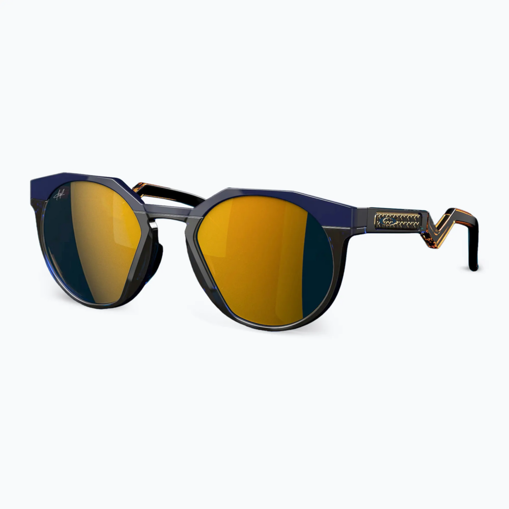 Close-up of stylish sunglasses with dark blue frames and yellow mirrored lenses on a light background, cropped at the bottom edge.