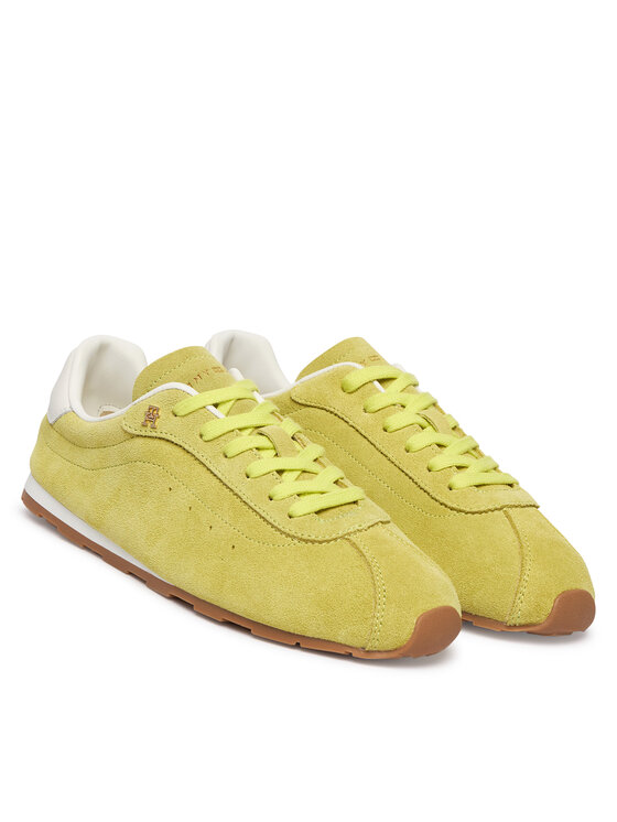 Pair of yellow suede sneakers with lime laces and brown outsole, shown from a front-side angle.