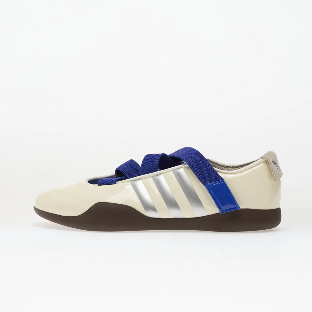 Side view of a cream-colored sneaker with blue adjustable straps and white stripes on the side.