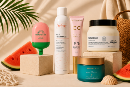 Assorted skincare products on display with watermelon slices and natural beige backdrop (Avène, Dermacol, L’Oréal, Rituals).