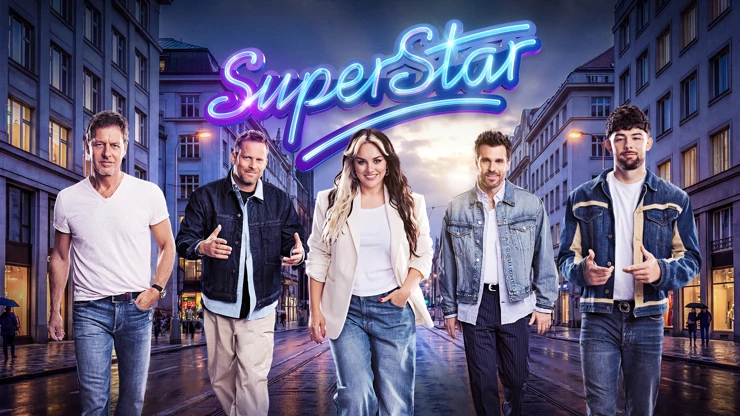 Five contestants walk toward the camera on a neon-lit city street under a bright 'SuperStar' sign (show poster vibe).